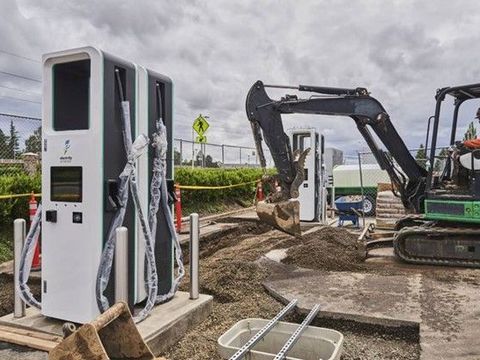 DC fast-charge cabinets on a plaza during construction
