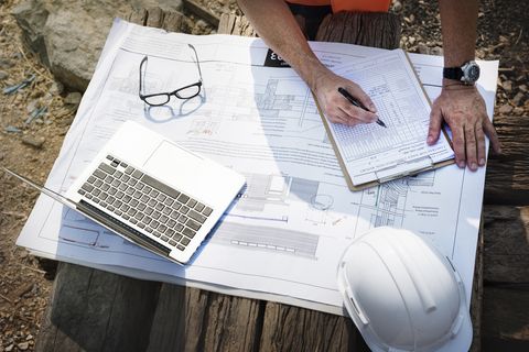 Construction drawings and laptop on a site table